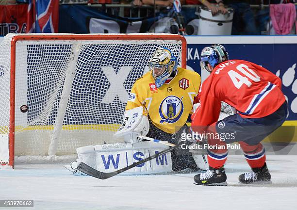 Darin Olver (#40 of Eisbaeren Berlin attempts to score against Lubos Horcicka of PSG Zlin during the Champions Hockey League group stage game between...