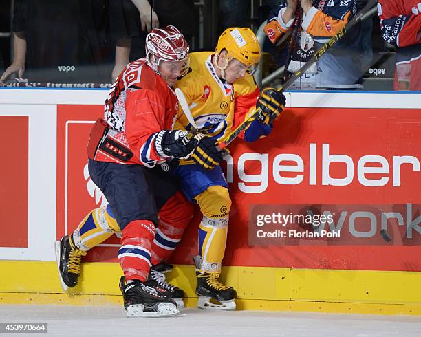 Mulock of Eisbaeren Berlin und Lubomir Kovarik of PSG Zlin body check during the Champions Hockey League group stage game between Eisbaeren Berlin...