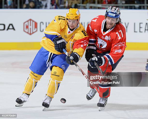 Petr Holik of PSG Zlin struggles for the puck with Mark Bell of Eisbären Berlin during the Champions Hockey League group stage game between Eisbaeren...