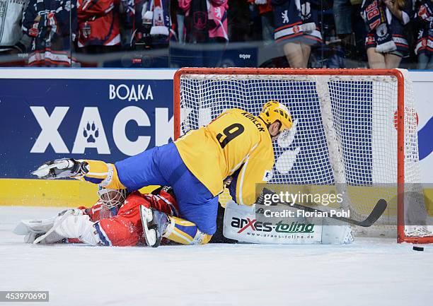 Bedrich Koehler of PSG Zlin attempts to score against Petri Vehanen of Eisbären Berlin during the Champions Hockey League group stage game between...