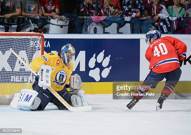 Darin Olver (#40 of Eisbaeren Berlin attempts to score against Lubos Horcicka of PSG Zlin during the Champions Hockey League group stage game between...