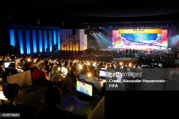 Members of the media work during a performance on stage during the Final Draw for the 2014 FIFA World Cup Brazil at Costa do Sauipe Resort on...