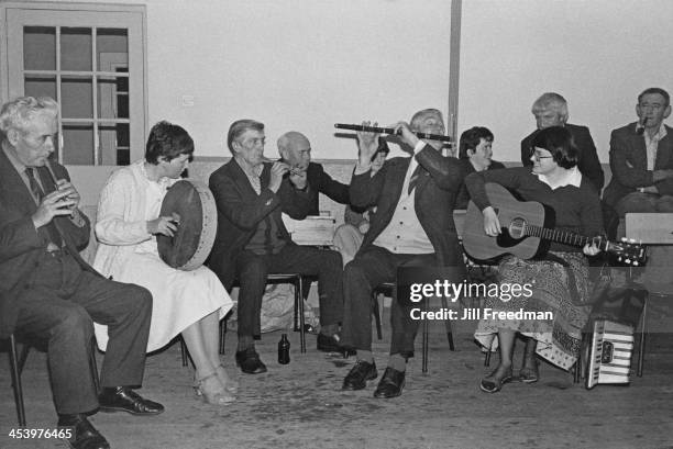 Local people play their instruments at a live music session in a schoolhouse, County Leitrim, Ireland, 1981.