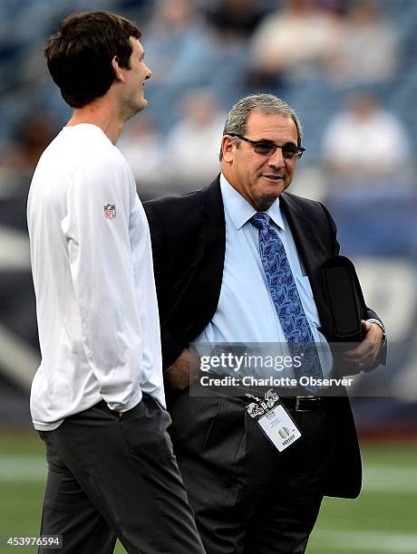 Carolina Panthers quarterbacks coach Ken Dorsey, left, and general manager Dave Gettleman talk prior to preseason action against the New England...