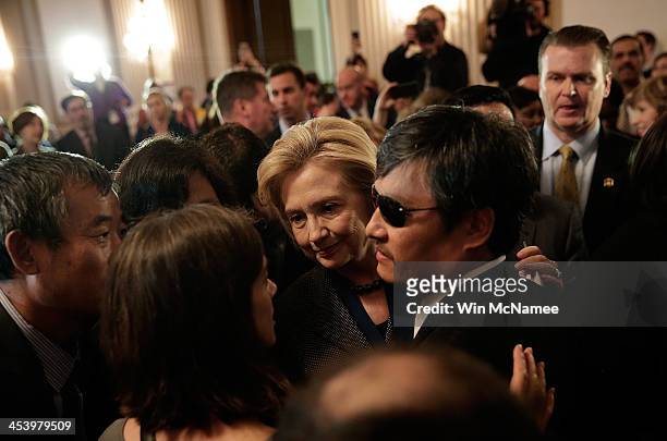 Former U.S. Secretary of State Hillary Clinton , recipient of the 2013 Tom Lantos Human Rights Prize, greets the 2012 recipient, Chinese dissident...