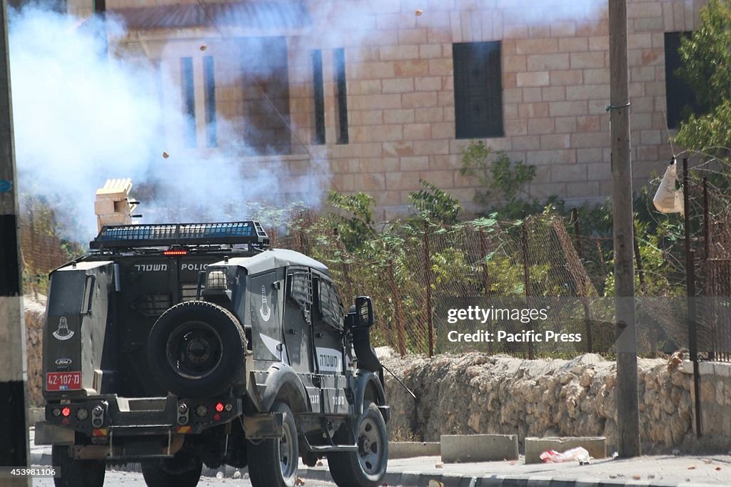 Rocks pelt an Israeli army jeep that is getting ready to...