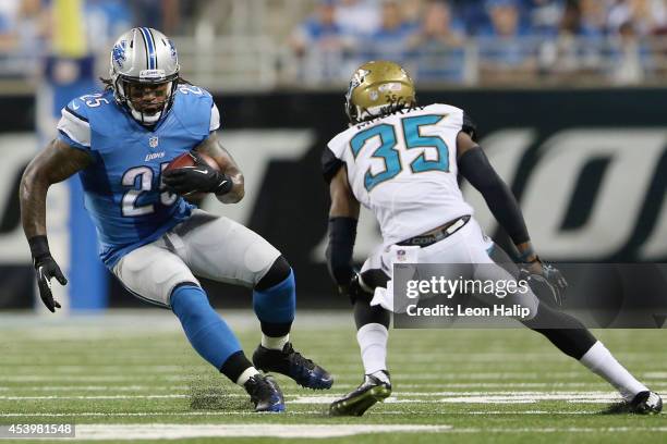 Mikel Leshoure of the Detroit Lions looks to get around Demetrius McCray of the Jacksonville Jaguars in the third quarter during a preseason game at...