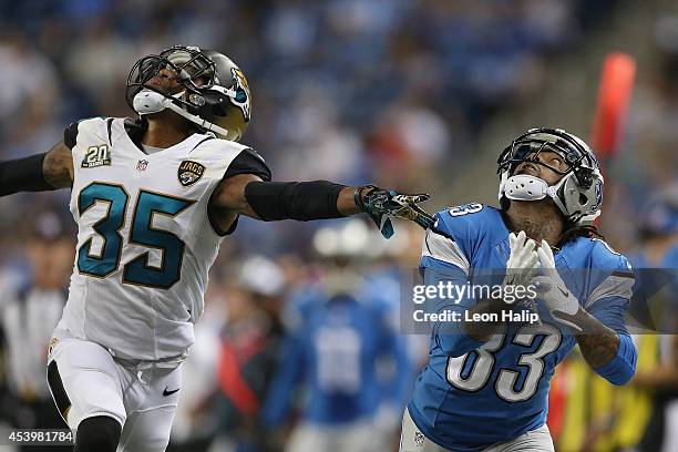 Pat Edwards of the Detroit Lions looks to intercept a pass in the third quarter in front of Demetrius McCray of the Jacksonville Jaguars during a...