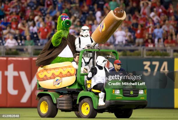 Stormtroopers help the Phillie Phanatic shoot hot dogs in the stands between innings of the game between the St. Louis Cardinals and Philadelphia...