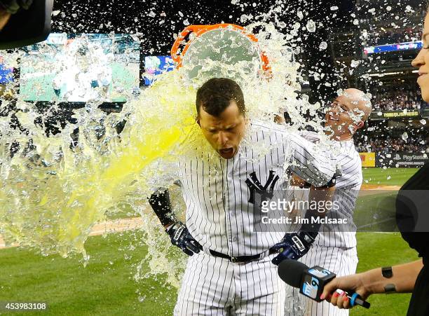 Martin Prado of the New York Yankees has Gatorade dumped on him by teammate Brett Gardner as they celebrate Prado's ninth inning game winning hit...