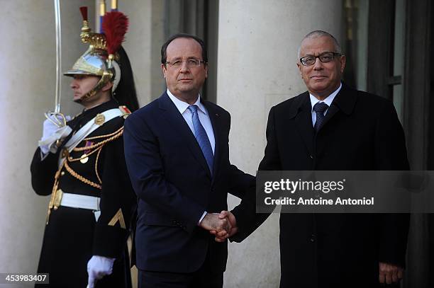 French President Francois Hollande welcomes Libyan Prime Minister Ali Zeidan for the Peace And Safety In Africa Summit at Elysee Palace on December...