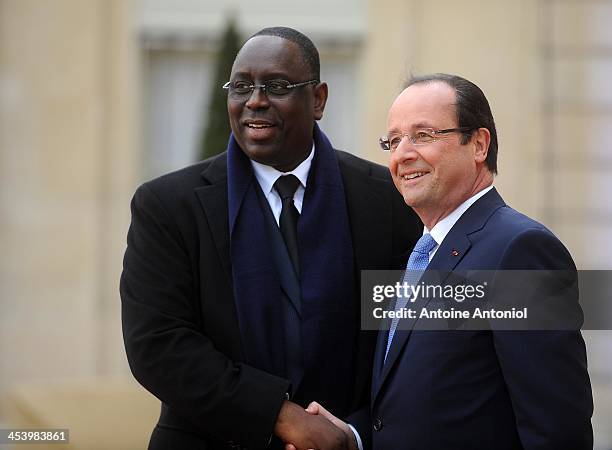 France's President Francois Hollande welcomes his Senegalese counterpart Macky Sall for the Peace And Safety In Africa Summit at Elysee Palace on...