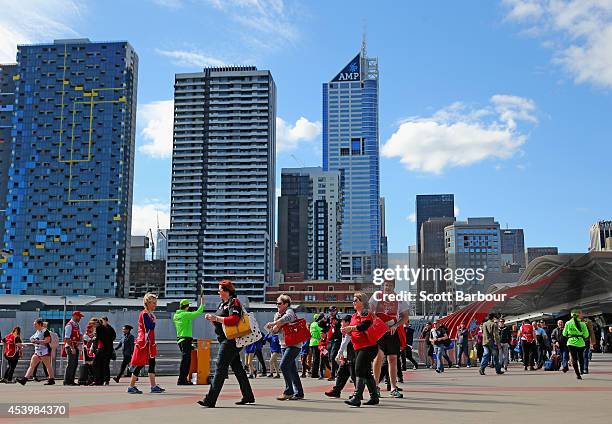 Fans arrive to attend the round 22 AFL match between the Essendon Bombers and the Gold Coast Suns at Etihad Stadium on August 23, 2014 in Melbourne,...
