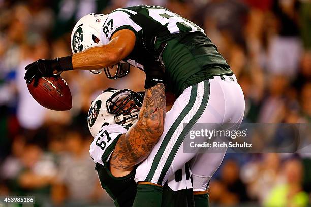 Eric Decker and Brian Winters of the New York Jets celebrate Decker's touchdown during the second quarter of a preseason game against the New York...