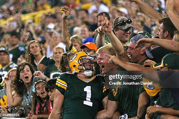 Alex Gillett of the Green Bay Packers celebrates his fourth quarter touchdown with a Lambeau leap during a preseason game against the Oakland Raiders...