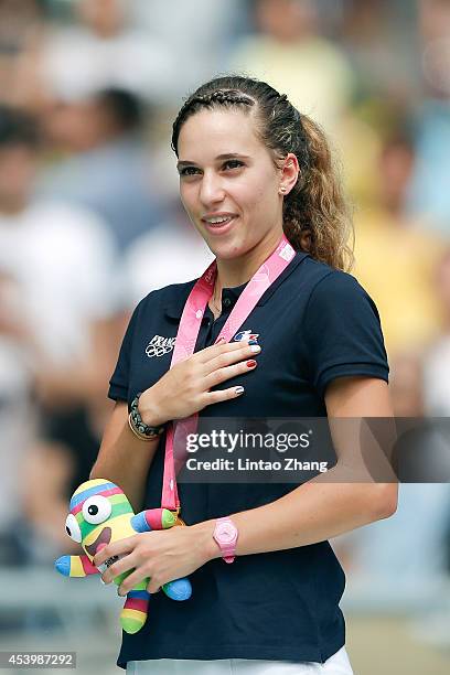 Laura Valette of France celebrates during the medal ceremony after the Women's 100m Hurdles Final of Nanjing 2014 Summer Youth Olympic Games at the...