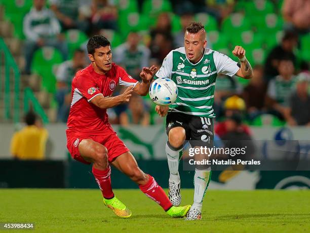 Mauro Cejas of Santos holds off the challenge by Francisco Gamboa of Toluca during a match between Santos Laguna and Toluca as part of 6th round...