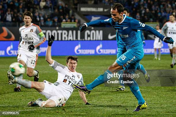 Roman Shirokov of FC Zenit St. Petersburg shoots on goal as Aleksandr Shchanitsyn of FC Ural Sverdlovsk Oblast defends during the Russian Football...