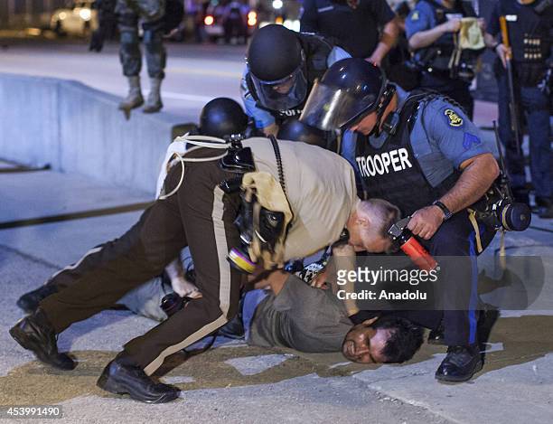 Anadolu Agency's correspondent in the U.S Bilgin Sasmaz is taken into custody by polices while he was covering protests in Ferguson, Missouri over...