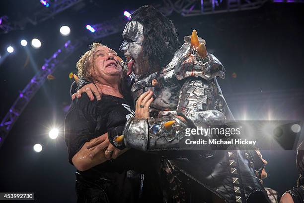 Joe Elliott of Def Leppard reacts as Gene Simmons of KISS leans in to lick his face after they performed the ALS Ice Bucket Challenge at Klipsch...