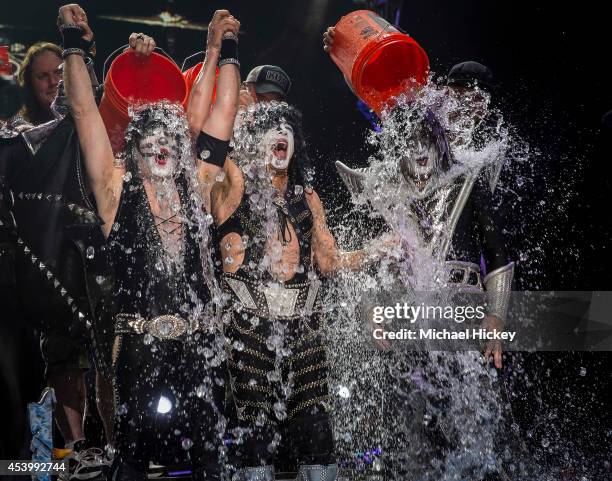 Eric Singer, Paul Stanley and Tommy Thayer of the band KISS participates in the ALS Ice Bucket Challenge at Klipsch Music Center on August 22, 2014...