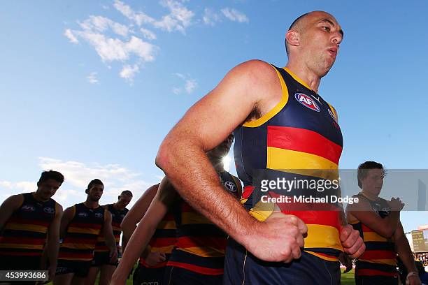 James Podsiadly of the Crows walk off the ground after defeat during the round 22 AFL match between the North Melbourne Kangaroos and the Adelaide...