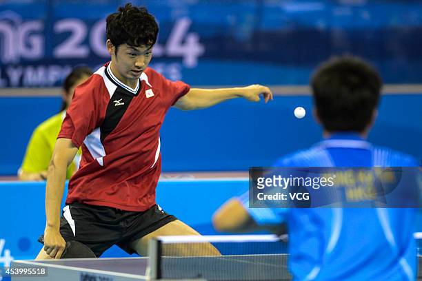Yuto Muramatsu of Japan competes in the Mixed International Team Semifinal 2 at Wutaishan Gymnasium during day seven of the Nanjing 2014 Summer Youth...