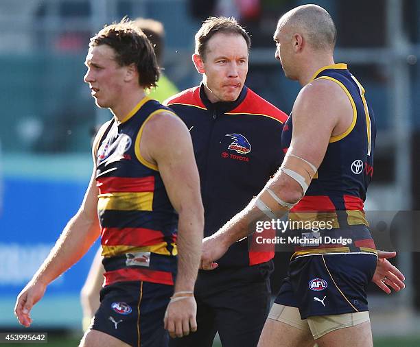 Crows coach Brenton Sanderson speaks to James Podsiadly of the Crows at three quarter time the round 22 AFL match between the North Melbourne...