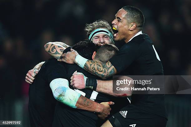 Steven Luatua of the All Blacks celebrates with Kieran Read and Aaron Smith after scoring a try during The Rugby Championship match between the New...