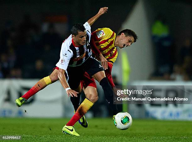 Zurdo of Cartagena competes for the ball with Bartra of Barcelona during the Copa del Rey, Round of 32 match between FC Cartagena and FC Barcelona at...