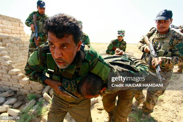 Shiite Muslim fighters, loyal to Iraqi Shiite cleric Moqtada al-Sadr, take part in a last combat training near the city of Najaf on August 23 before...