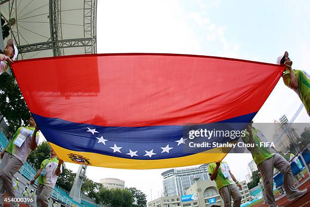 The national flag of Venezuelais carried onto the pitch prior to kick off during the 2014 FIFA Girls Summer Youth Olympic Football Tournament Semi...