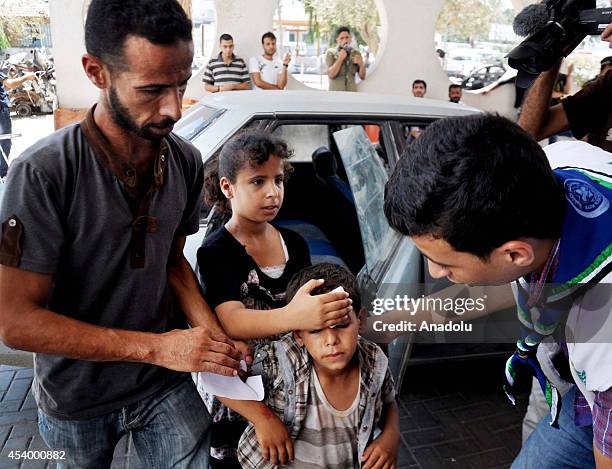 Wounded Palestinians are carried to Al-Shifa hospital after Israeli atatcks to Gaza, on August 23, 2014. Israeli army have hit 3 mosque and 30...