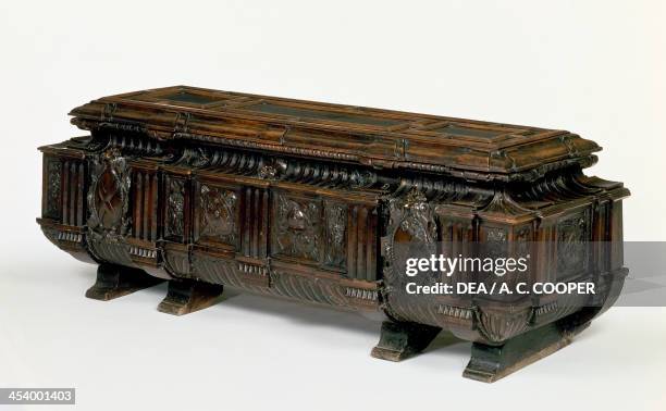 Sarcophagus form wedding chest in walnut with coats of arms, medallions and carved masks, made in Rome. Italy, 16th century.