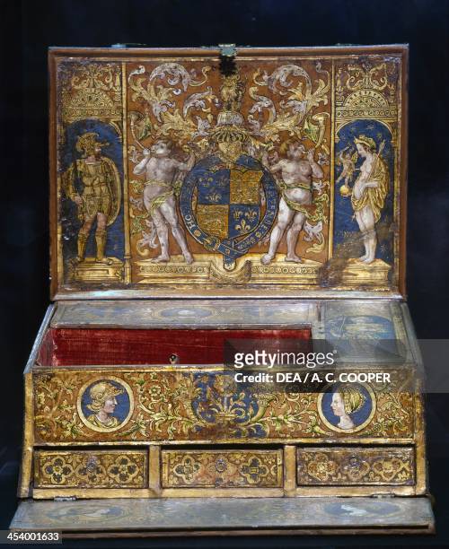 Writing table, ca 1525, tooled, painted and gilt leather upholstery, inside the cover of Henry VIII's heraldic shield supported by two cherubim and...