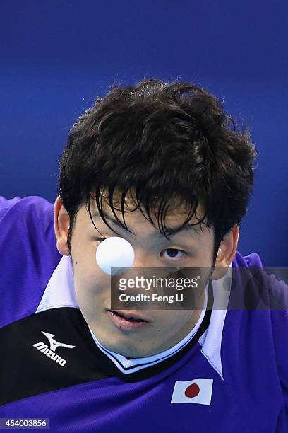 Yuto Muramatsu of Japan competes Fan Zhendong of China in table tennis Mixed International Team Gold Medal match during day seven of the Nanjing 2014...