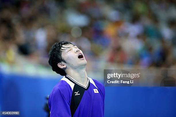 Yuto Muramatsu of Japan competes Fan Zhendong of China in table tennis Mixed International Team Gold Medal match during day seven of the Nanjing 2014...