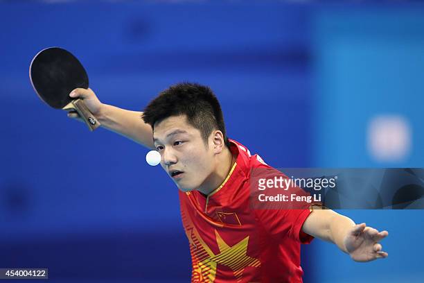 Fan Zhendong of China competes Yuto Muramatsu of Japan in table tennis Mixed International Team Gold Medal match during day seven of the Nanjing 2014...