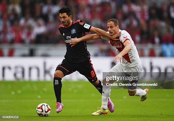 Tolgay Arslan of Hamburger SV and Matthias Lehmann of 1. FC Koeln battle for the ball during the Bundesliga match between 1. FC Koeln and Hamburger...