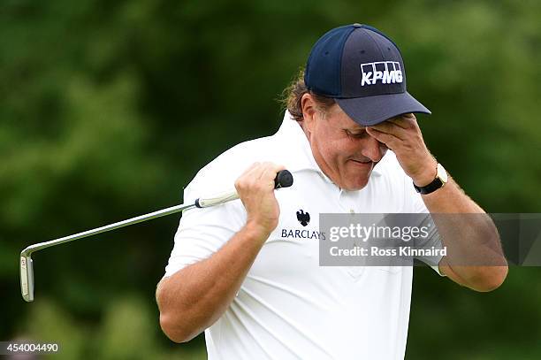 Phil Mickelson reacts after missing a putt for birdie on the 10th green during the third round of The Barclays at The Ridgewood Country Club on...