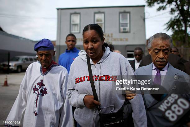 Wife of Eric Garner, next to Rev. Herbert Daughtry, left, and Rev. Al Sharpton arrive to attend a church service before a rally against police...