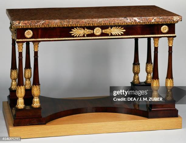 Empire style mahogany centre table with veneer finish, eight Egyptian columns and antique plated pink marble. Spain, late 18th century.
