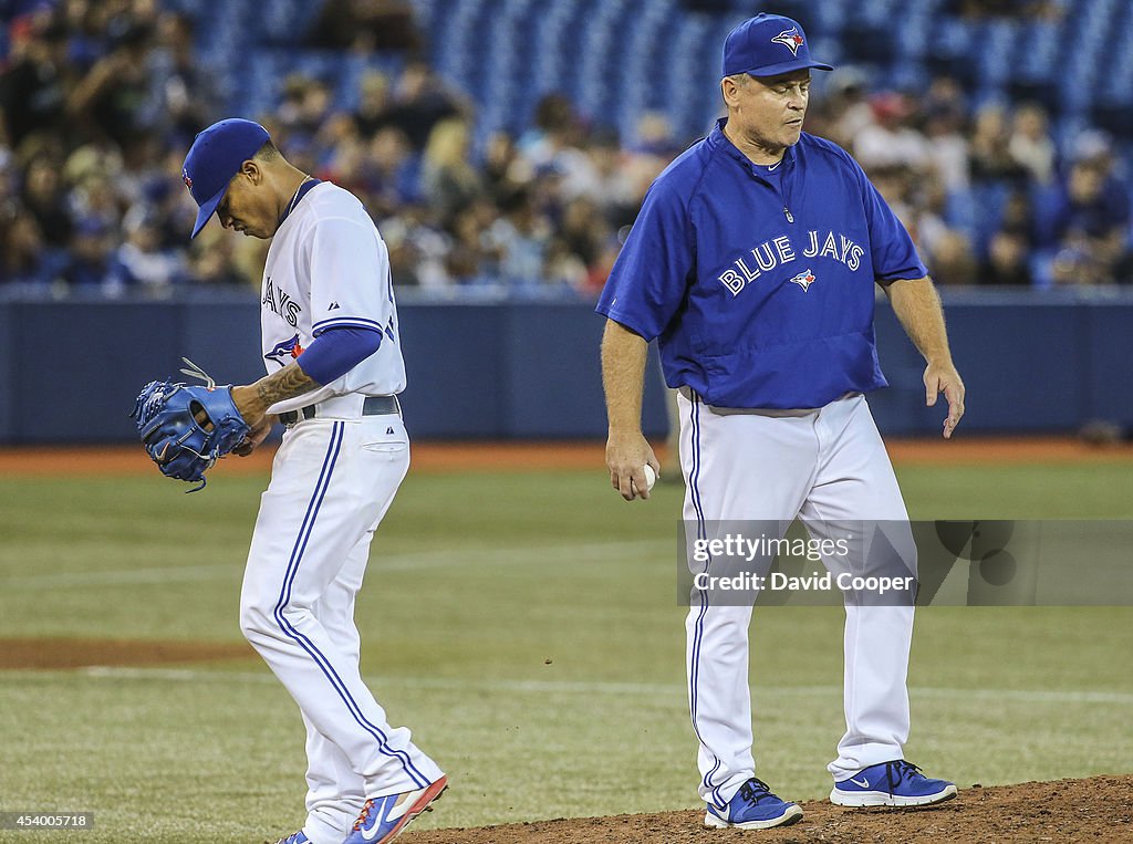 Marcus Stroman (54) of the Toronto Blue Jays heads for the dugout after handing over the ball to Jays manager John Gibbons (5)