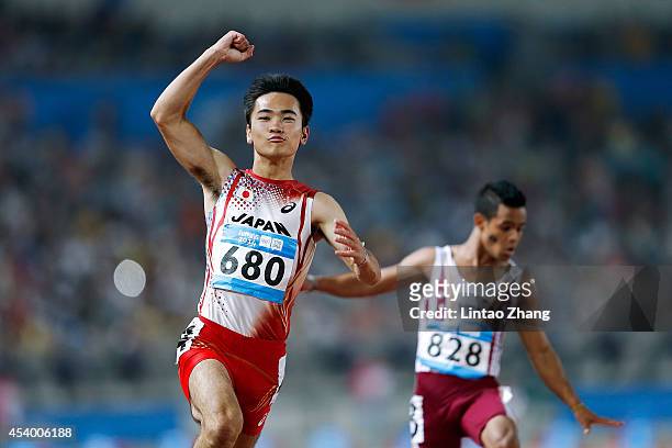 Kenta Oshima of Japan celebrates after the Men's 100m Final of Nanjing 2014 Summer Youth Olympic Games at the Nanjing Olympic Sports Centre on August...