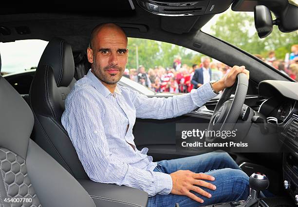 Josep Guardiola, head coach of FC Bayern Muenchen poses in his car during the car handover of Audi on August 23, 2014 in Neuburg an der Donau,...
