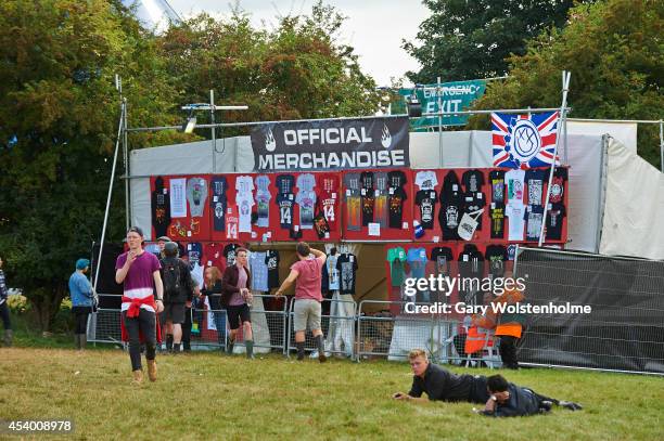 Festival goers purchase official merchandise during the second day of Leeds Festival at Bramham Park on August 23, 2014 in Leeds, United Kingdom.