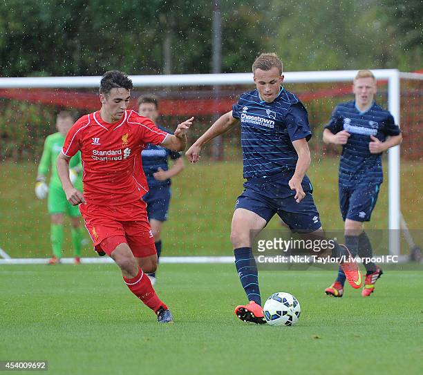 Adam Phillips of Liverpool and Charles Vernam of Derby County in action during the Barclays Premier League Under 18 fixture between Liverpool and...