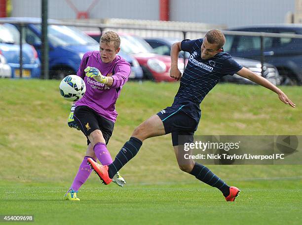Liverpool goalkeeper Andrew Firth and Charles Vernam of Derby County in action during the Barclays Premier League Under 18 fixture between Liverpool...