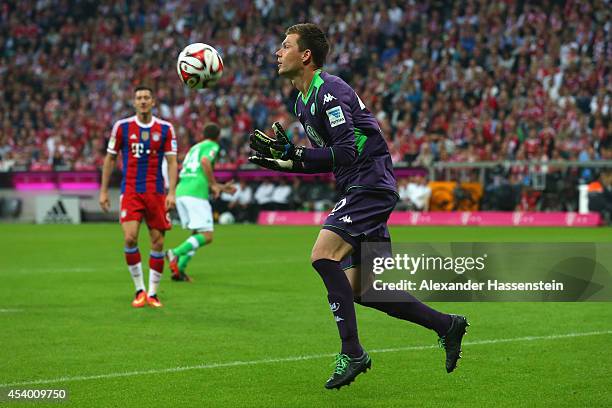 Max Gruen, keeper of Wolfsburg safes the ball during the Bundesliga match between FC Bayern Muenchen and VfL Wolfsburg at Allianz Arena on August 22,...