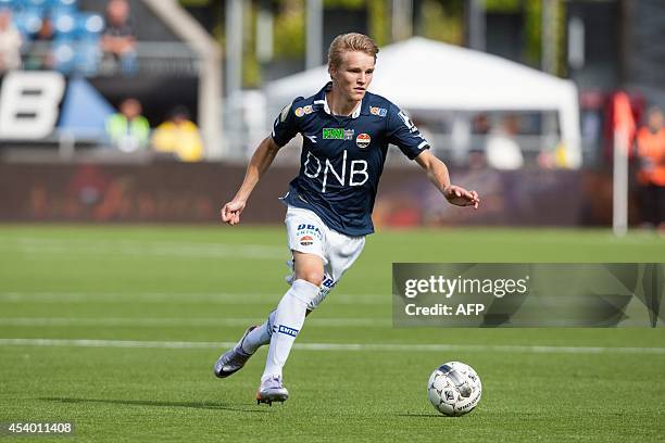 Stromsgodset IF's midfielder Martin Oedegaard runs with the ball during the football match Stromsgodset IF vs Stabaek IF on August 23, 2014 in...